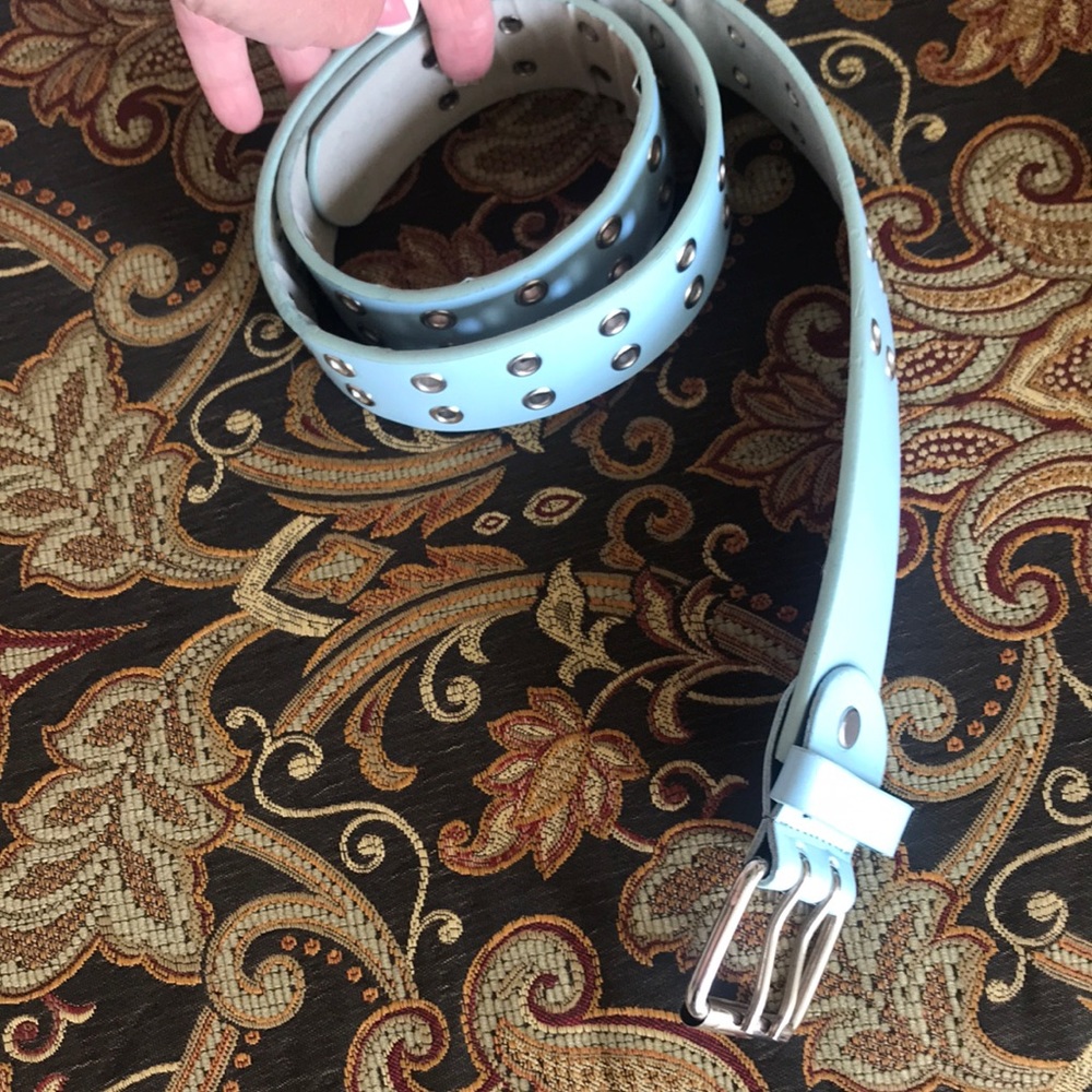 Women’s baby blue belt with Silver riveted holes. Size large.